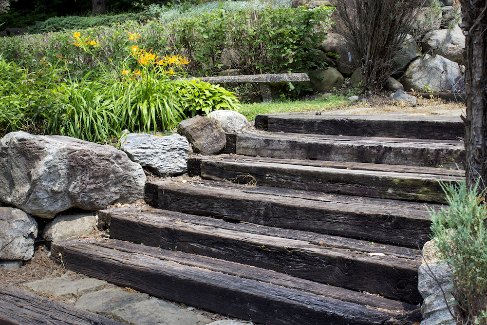 How To Use Railway Sleepers In Your Garden Bury Hill Topsoil And Logs Blog Gardening Advice - How Do I Build A Retaining Wall With Railway Sleepers